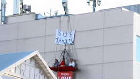 Christian protesters arrested after protest hanging four storeys above minister's building