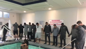 Star American footballer baptized in hotel swimming pool before big game between Carolina Panthers and Philadelphia Eagles