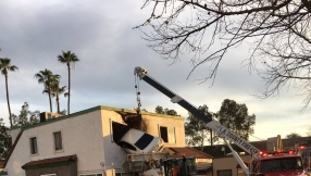 California car crashes into second floor of office block, two people saved