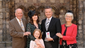 Hymn writer Keith Getty receives his OBE insignia from the Queen