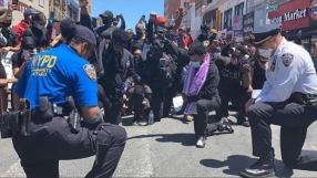 Police officers kneel to pray with George Floyd protesters