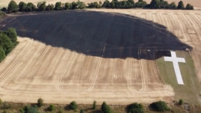 Memorial cross survives fire that swept through field during heatwave 