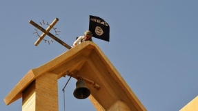 ISIS militants desecrate Iraqi church, replace cross with black flag