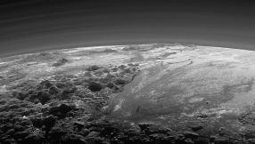 In far-away Pluto, surface water ice is red and sky is blue, similar to Earth\'sâNASA