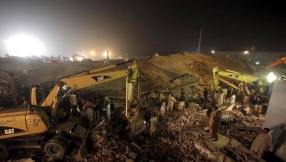 Workers trapped in collapsed Pakistan factory plead for help on mobile phones 