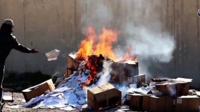 Islamic State jihadists set fire to hundreds of Christian books in Mosul