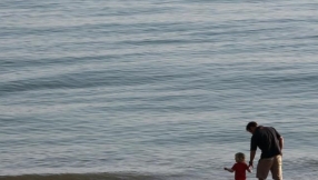 Christian minister performs risky baptism ritual as Storm Katie batters U.K. beach